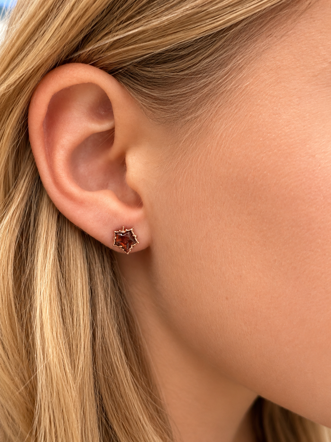 Petite 11 mm Baltic amber maple leaf stud earring shown on ear for size reference